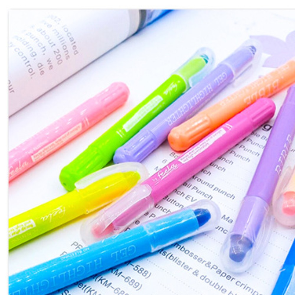 Twist-up jelly gel highlighters on an open book